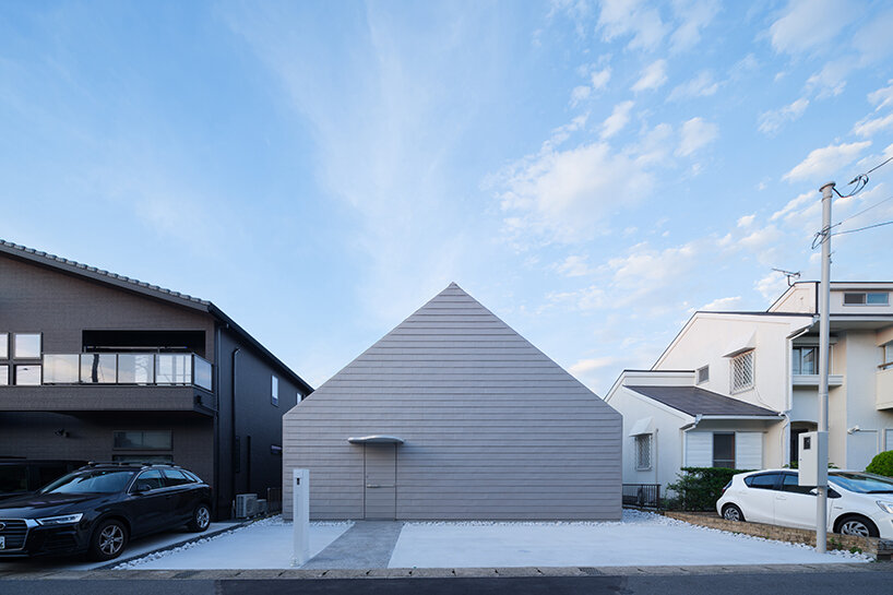 metallic steel sheets clad residence by MASA architects, reflecting the changing sky in japan