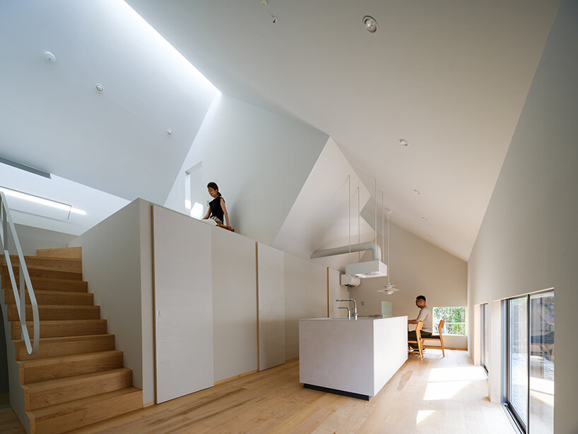 metallic steel sheets clad residence by MASA architects, reflecting the changing sky in japan