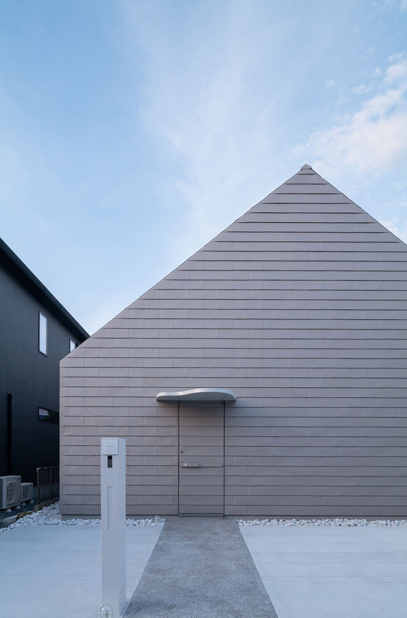 metallic steel sheets clad residence by MASA architects, reflecting the changing sky in japan